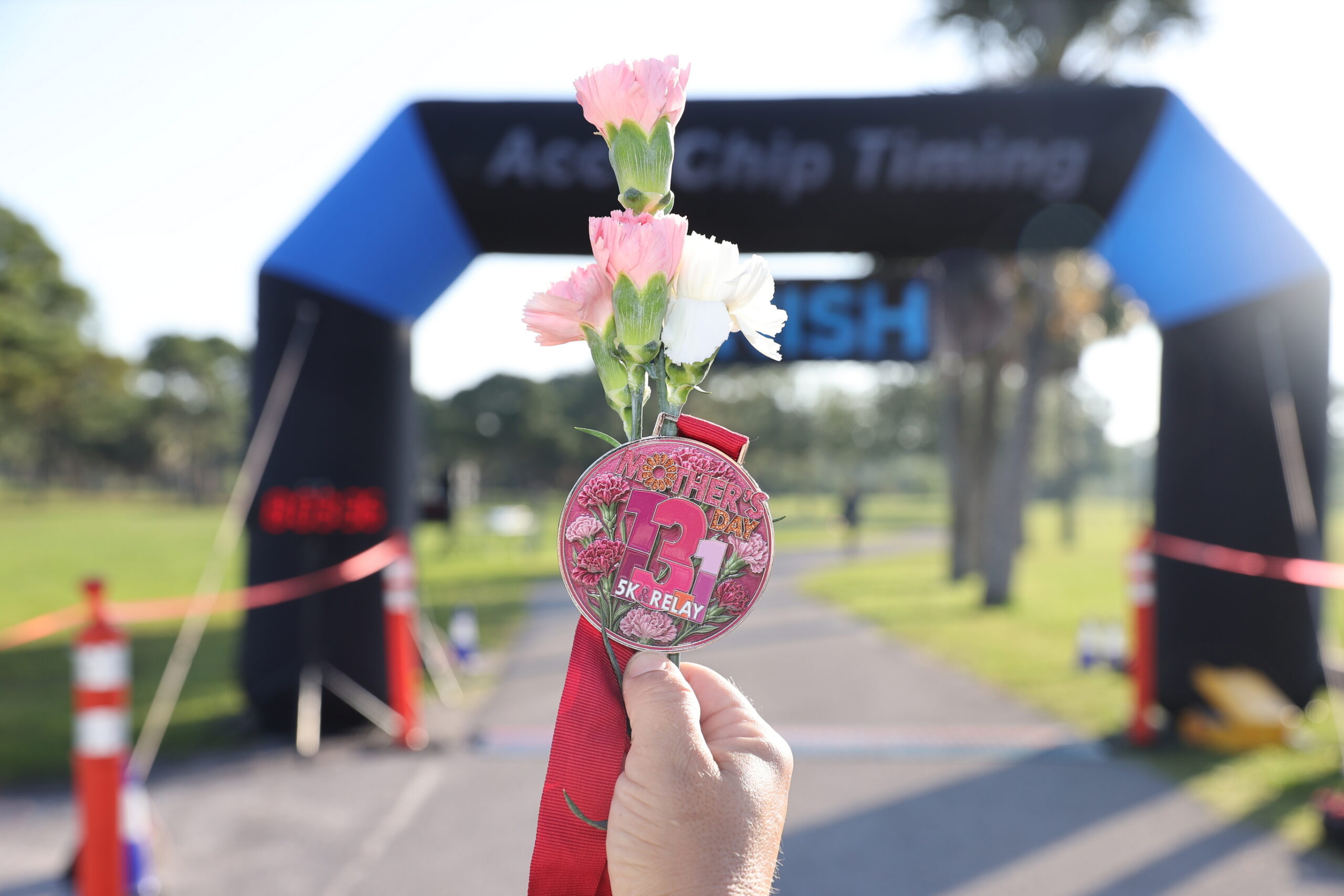 Runner receiving a flower at the finish line